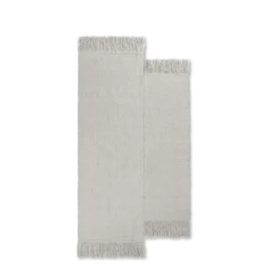 Alter Rug in natural, two offset woven panels with long fringed ends